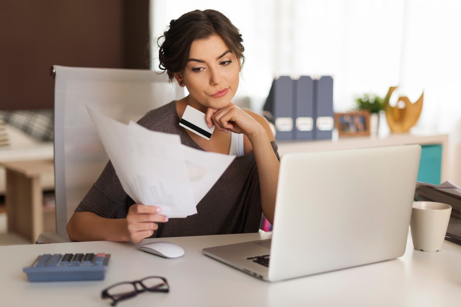 pensive-woman-paying-bills-home (1)